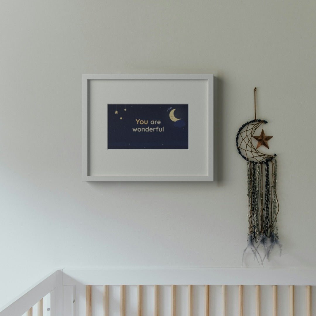 Quoteplume Kids frame in a calm nursery showing "You are wonderful" with a bedtime moon